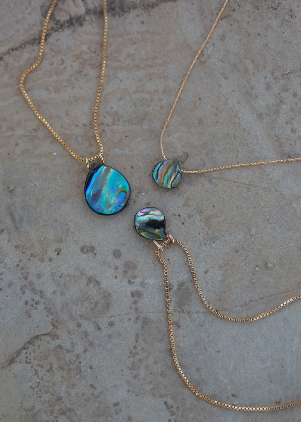 Three iridescent blue/green abalone necklaces with 14k gold chains.