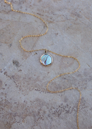 Abalone set in a round gold bezel with a dainty cable chain