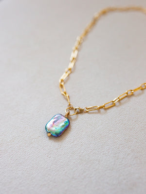 Close up view of pearl pendant and the front-fastening gold chain
