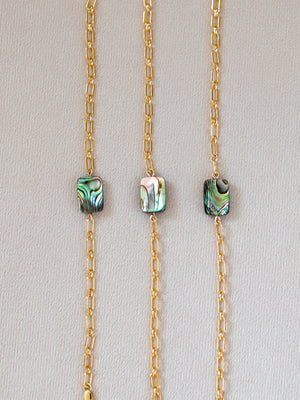Three gold bracelets with abalone shell beads