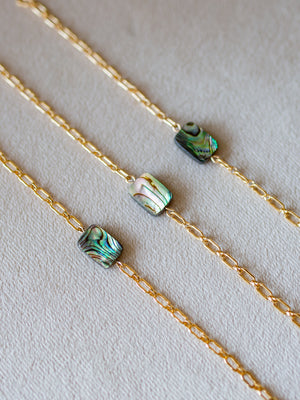 Gold chain bracelets with abalone shell bead in the center