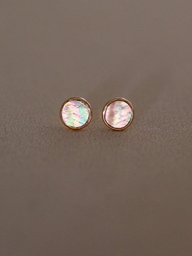 Pair of round gold earring studs with iridescent mother of pearl
