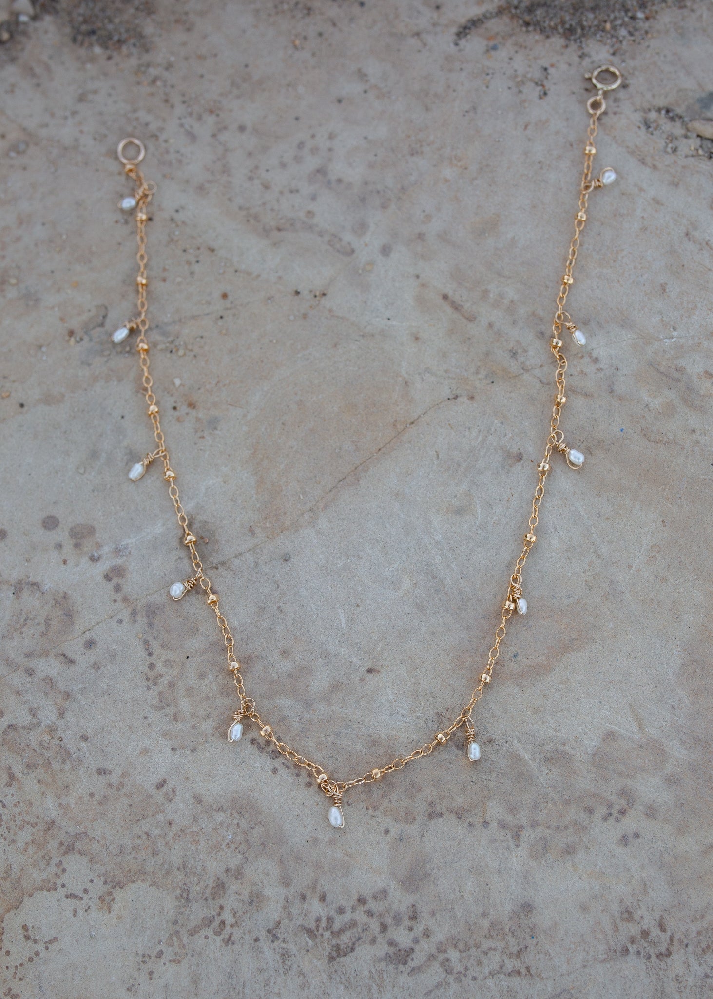 Gold chain with small pearls dotting the length