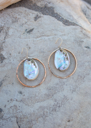 Hammered gold hoop with whole iridescent abalone shells inthe center